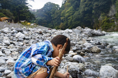 Rear view of boy on rock