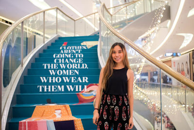 Portrait of smiling young woman standing outdoors