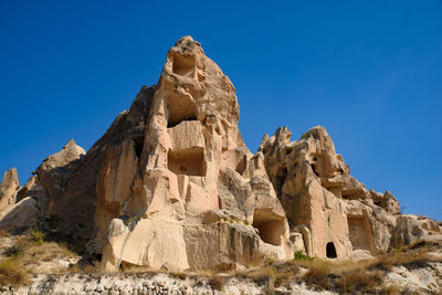 Low angle view of rock formation against blue sky