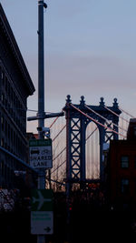 Road sign against sky in city