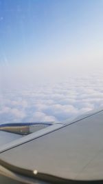 Close-up of airplane wing against sky