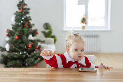 Portrait of cute girl sitting on table