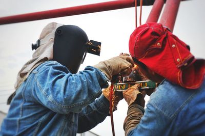 Workers welding metal