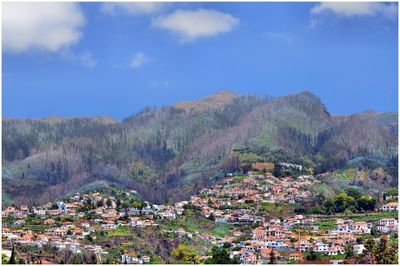 Townscape by mountain against sky