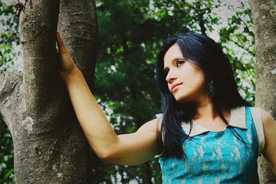 Smiling beautiful woman in forest