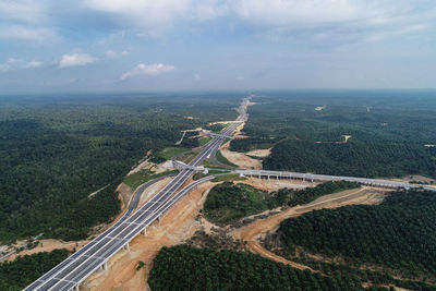 High angle view of road by land against sky