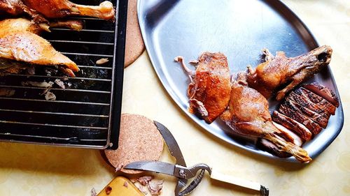 High angle view of meat on barbecue grill