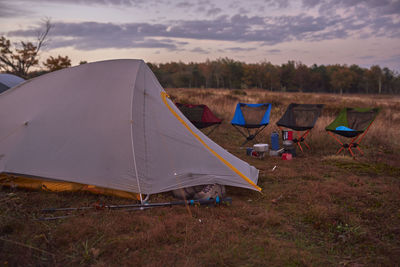 Tent on field against sky