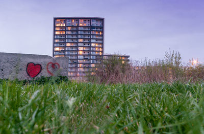 Building on field against sky
