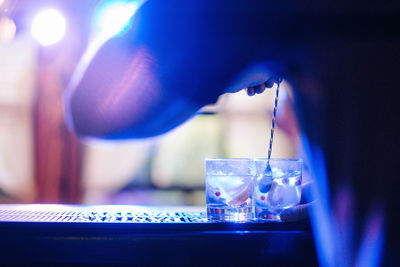 Close-up of illuminated pouring coffee in glass