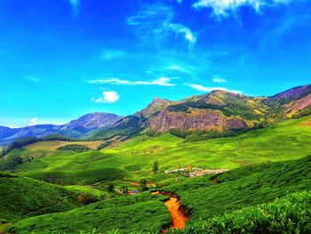 Scenic view of mountains against blue sky