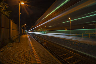 Blurred motion of railroad station platform at night