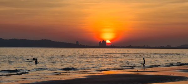 Scenic view of sea against orange sky