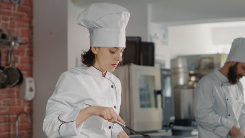 Female chef working in kitchen