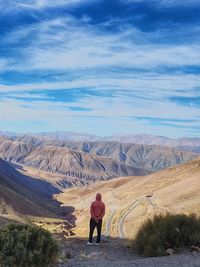 Rear view of man on landscape against sky