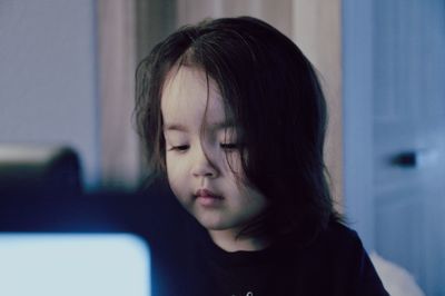 Close-up portrait of a girl looking away at home