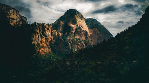 Scenic view of mountains against cloudy sky