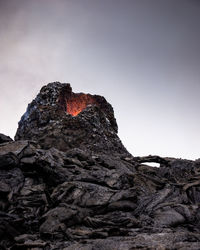 Low angle view of rock formation against sky