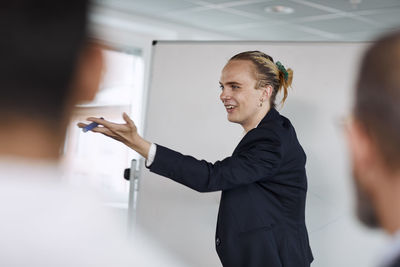 Smiling man having presentation at meeting