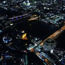 High angle view of city lit up at night