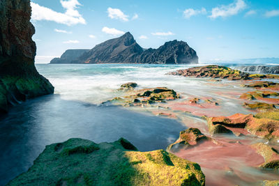 Scenic view of sea and rocks against sky