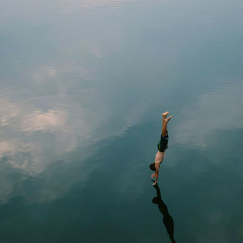 High angle view of man diving into calm lake