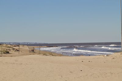 Scenic view of beach against clear sky