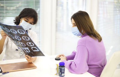 Side view of young woman working at home