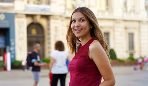 Young woman looking away in city