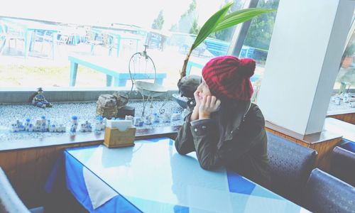 Woman sitting on table in restaurant