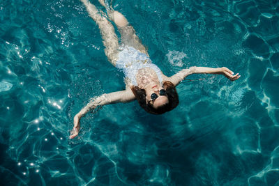 High angle view of woman swimming in sea