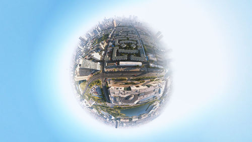 Digital composite image of buildings against clear sky