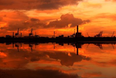 Scenic view of harbor against cloudy sky