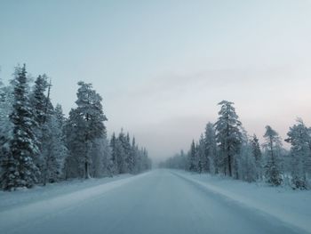 Snow covered road against sky
