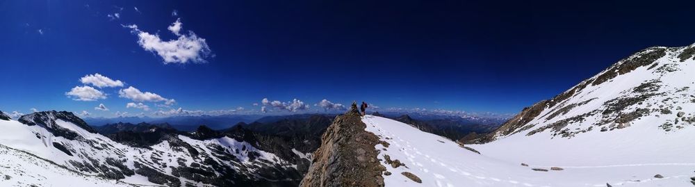 Panoramic view of snowcapped mountains against sky