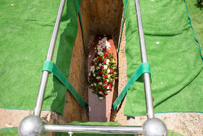 Closeup shot of a funeral casket or coffin in a hearse or chapel or burial at cemetery
