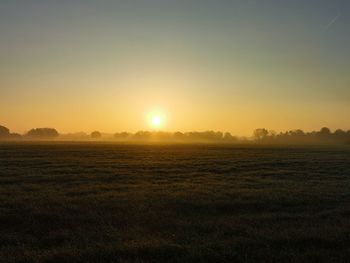 Scenic view of field against sky during sunset