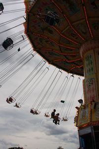 Low angle view of ferris wheel against sky