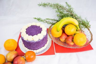 Close-up of cake and fruits on table during christmas