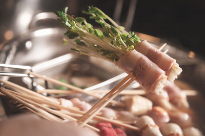 Shabu put in stick style of ham and bean sprouts for grab and bite after boil in the bowl of soup