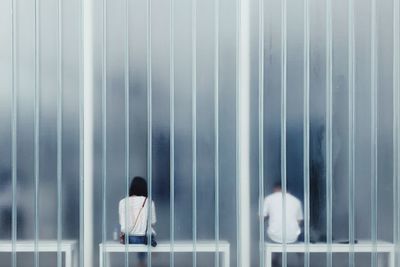 Rear view of people walking in building