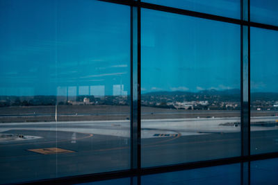 View of airport seen through glass window