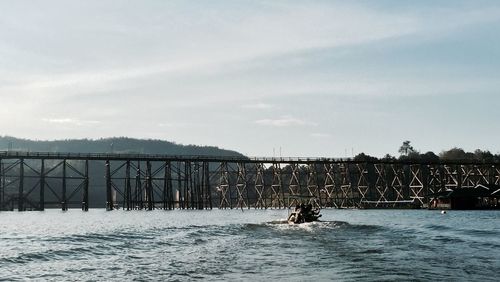 Bridge over river with city in background