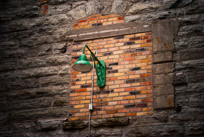 Clothes hanging on brick wall