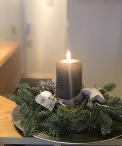 Close-up of illuminated candles on table