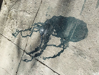 High angle view of shadow of person riding bicycle on footpath