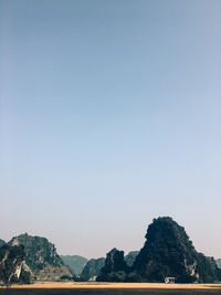 Scenic view of mountains against clear blue sky