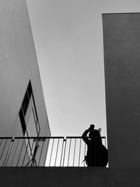 Low angle view of silhouette man standing against clear sky