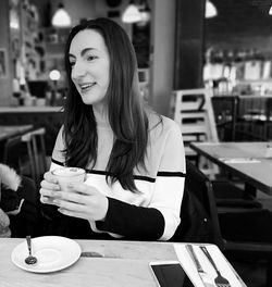 Woman sitting at restaurant table