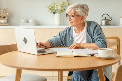 Young woman using laptop at home